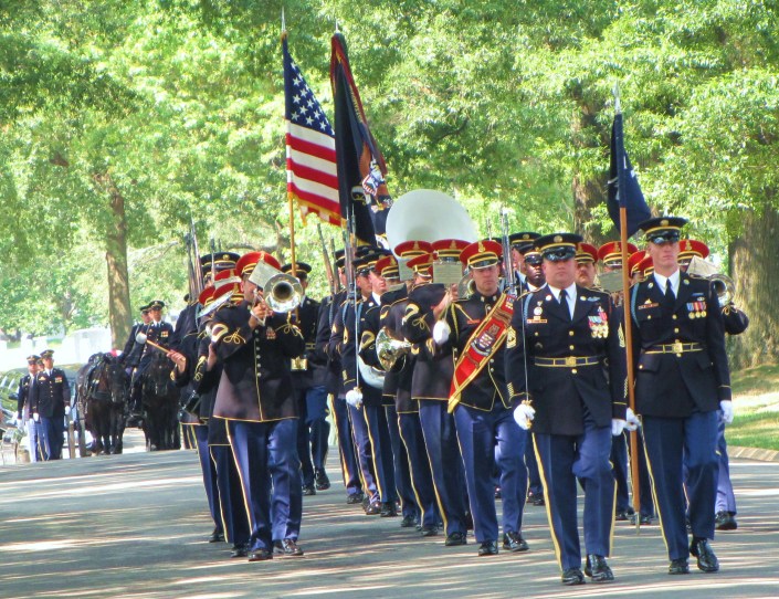The Army's Old Guard escorts the caisson containing three fallen heroes' remains to their final resting place in Arlington National Cemetery.