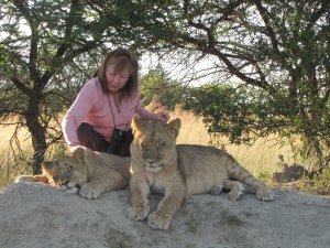 My wife Myung petting young lions at Antelope Park, near Harare, Zimbabwe.